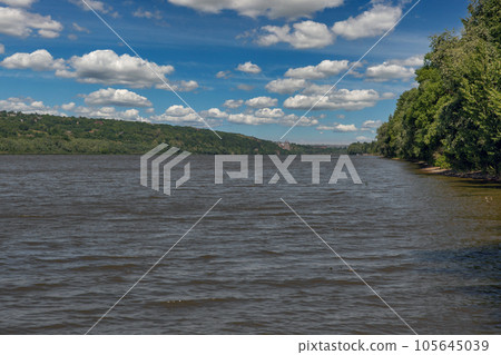 Dnister river banks with Khotyn fortress in the background, Ukraine. Dnister river banks with Khotyn fortress in the background, Ukraine. 105645039
