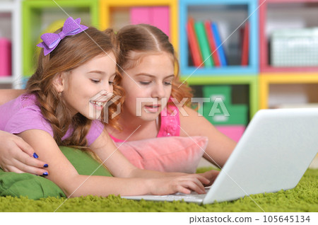woman and girls using laptop 105645134