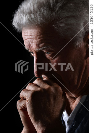 Close-up portrait of a senior man thinking about something 105645136