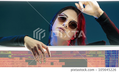 Cyber information. Data protection. Virtual access. Red blue neon light confident woman in sunglasses with colorful encryption glitch noise on teal background. Cyber information. Data protection. Virtual access. Red blue neon light confident woman in sunglasses with colorful encryption glitch noise on teal background. 105645226