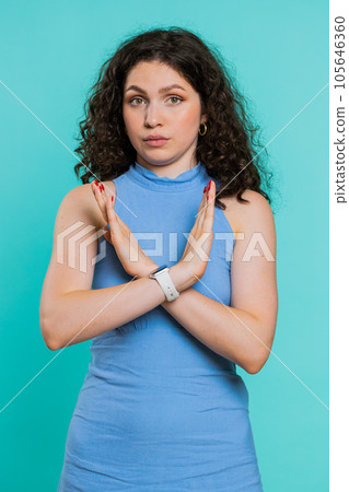 Woman say No hold palm folded crossed hands in stop gesture warning of finish prohibited access 105646360