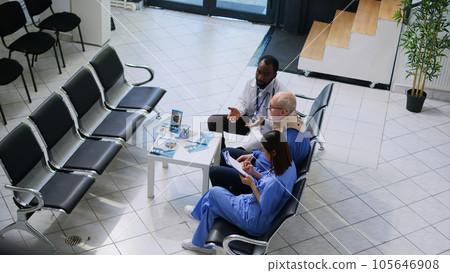 Doctor explaining medical expertise to elderly man during checkup visit consultation, nurse writing medication treatment on clipboard. Senior patient wearing cervical collar after neck injury 105646908
