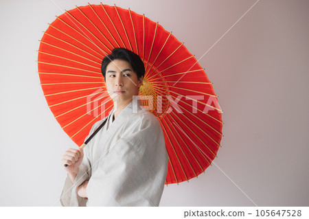 A man in a kimono, a Japanese umbrella A man in a kimono, a Japanese umbrella 105647528