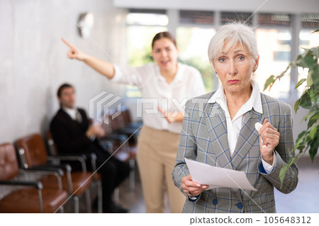 Young woman chief screaming to mature female manager during working Young woman chief screaming to mature female manager during working 105648312