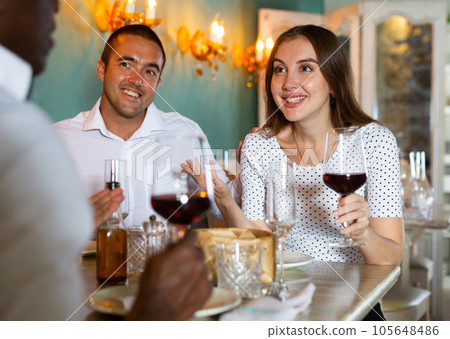 Young people and their friend in the restaurant 105648486