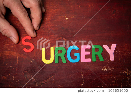 SURGERY Concept. Text from colorful alphabet letters on wooden table 105651600