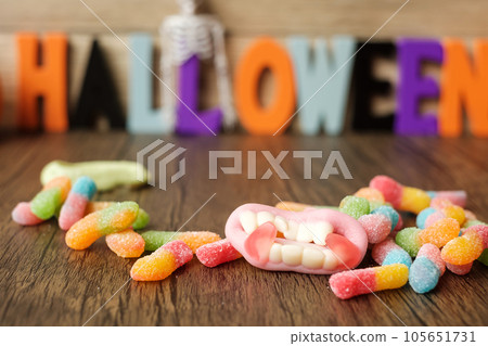 Happy Halloween day with ghost candies, pumpkin bowl, Jack O lantern and decorative (selective focus). Trick or Threat, Hello October, fall autumn, Festive, party and holiday concept 105651731