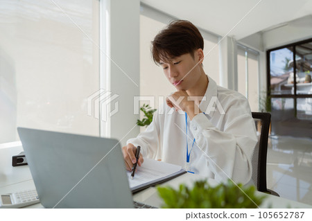 business man stress paperwork and deadline concept stressed businessman with papers and charts sitting at table in office business man stress paperwork and deadline concept stressed businessman with papers and charts sitting at table in office 105652787