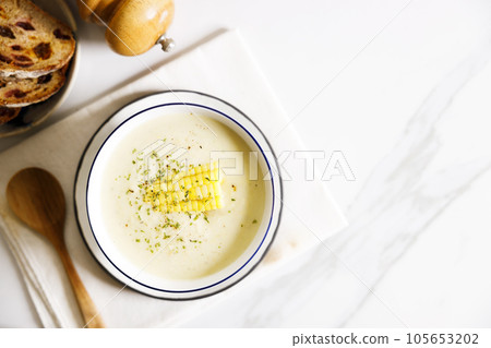 Creamy corn soup in white bowl. 105653202