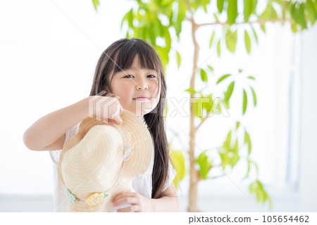 Portrait of a girl A girl holding a straw hat 105654462