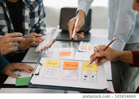 ui designer brainstorming about mobile app interface wireframe design with customer breif and color code at office. ui designer brainstorming about mobile app interface wireframe design with customer breif and color code at office. 105654684