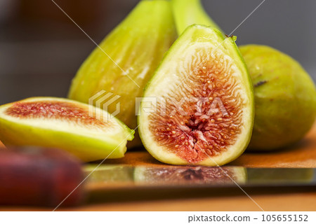 Ripe fresh figs on a wooden board with a knife. Ripe tasty figs 105655152