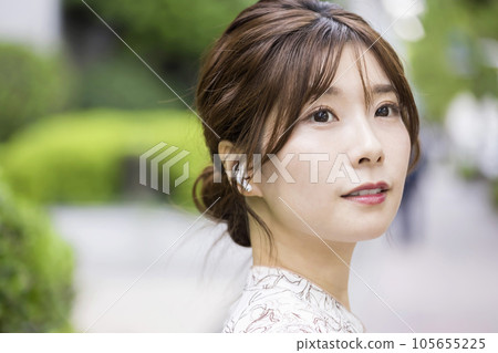 戴著無線耳機在城市行走的年輕女子 105655225