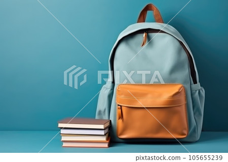 School bag and textbooks in front of a blue background. Back to school concept 105655239
