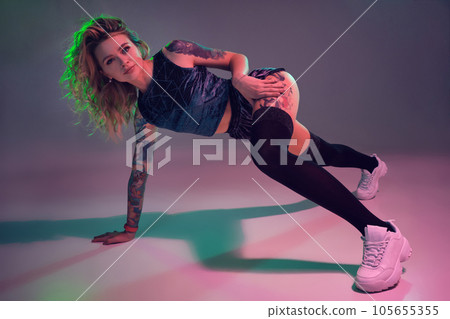 beautiful caucasian blonde girl in velour blue booty shorts and black stockings dancing twerk on pink background beautiful caucasian blonde girl in velour blue booty shorts and black stockings dancing twerk on pink background 105655355