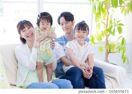 Family portrait of a family sitting on a sofa Family portrait of a family sitting on a sofa 105655671
