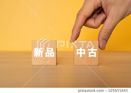 A hand grabbing a block that says used A hand grabbing a block that says used 105655845