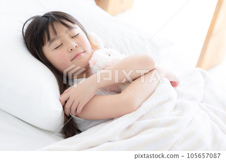A girl sleeping in bed 105657087