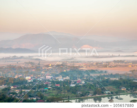 Natural viewpoint, mountains, hills, forests and river under morning mist 105657880