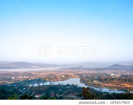 Natural viewpoint, mountains, hills, forests and river under morning mist Natural viewpoint, mountains, hills, forests and river under morning mist 105657903