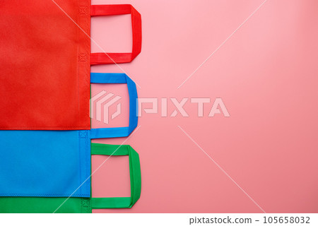 Colorful shopping bags on pink background. Mockup for design. Colorful shopping bags on pink background. Mockup for design. 105658032