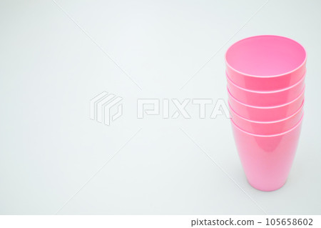 Pink plastic cups for camping, travel, trip isolated on white 105658602