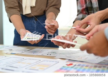 Developer team working on development project for mobile application at creative office. User experience concept 105660058