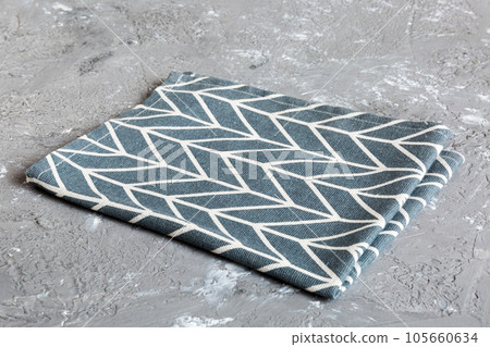 top view with blue kitchen napkin isolated on table background. Folded cloth for mockup with copy space, Flat lay. Minimal style top view with blue kitchen napkin isolated on table background. Folded cloth for mockup with copy space, Flat lay. Minimal style 105660634