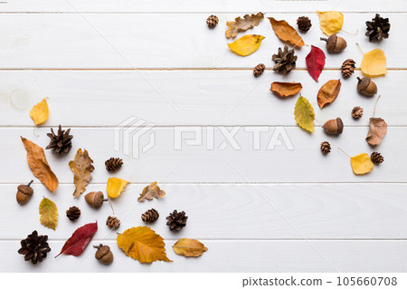 Autumn composition. Pattern made of dried leaves and other design accessories on table. Flat lay, top view Autumn composition. Pattern made of dried leaves and other design accessories on table. Flat lay, top view 105660708
