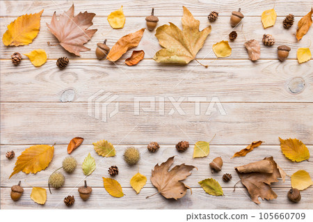 Autumn composition. Pattern made of dried leaves and other design accessories on table. Flat lay, top view Autumn composition. Pattern made of dried leaves and other design accessories on table. Flat lay, top view 105660709