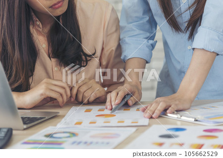Happy success business woman partner working together in company office corporate executive teamwork. Meeting Executive Asian business woman using laptop office desk with fist arm raised win happiness 105662529