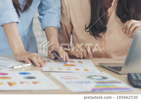 Happy success business woman partner working together in company office corporate executive teamwork. Meeting Executive Asian business woman using laptop office desk with fist arm raised win happiness 105662530