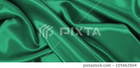 Smooth elegant green silk or satin luxury cloth texture as abstract background. Luxurious background design 105662604