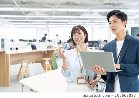 Male and female young engineers having a meeting while operating a personal computer in the office Male and female young engineers having a meeting while operating a personal computer in the office 105662858