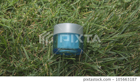 Cosmetics, skin care, beauty concept. blue cosmetic jar on green background. Top view. eco friendly. Flat lay. spice for tex Cosmetics, skin care, beauty concept. blue cosmetic jar on green background. Top view. eco friendly. Flat lay. spice for tex 105663187