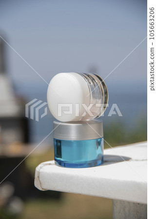 A top view of a organic cosmetic cream for face or body. Close-up. Natural lighting. Sunlight. Scin care concept. A top view of a organic cosmetic cream for face or body. Close-up. Natural lighting. Sunlight. Scin care concept. 105663206