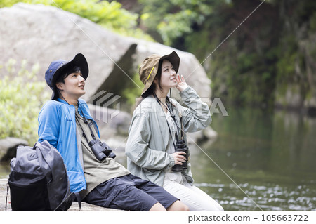 Young couple birdwatching on the river bed 105663722