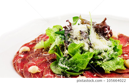 Veal carpaccio with parmesan cheese on white plate 105664022