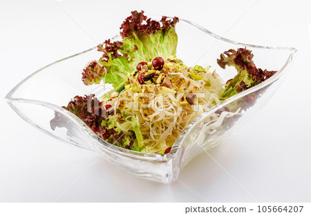 coleslaw with pistachios in a glass bowl 105664207