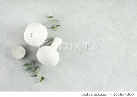 Top view photo of Spa set with massage herbal balls on grey background top view copy space 105664300