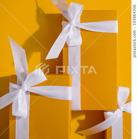 Yellow gifts on a yellow background Yellow gifts on a yellow background 105664306