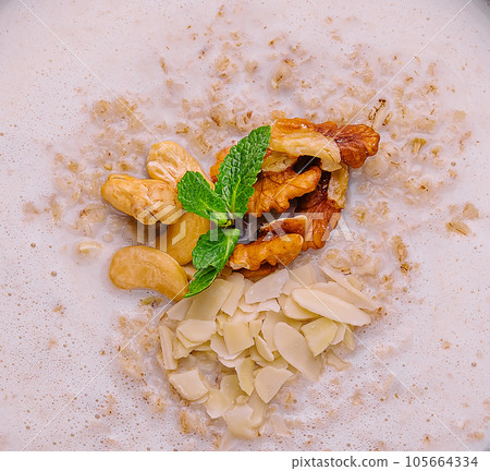 Homemade oatmeal flakes porridge with nuts Homemade oatmeal flakes porridge with nuts 105664334