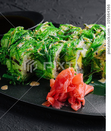 set sushi rolls in seaweed on black plate set sushi rolls in seaweed on black plate 105664366