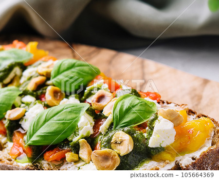 bruschetta with pesto, hazelnuts, cheese and basil 105664369