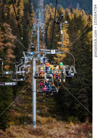 Family sitting inside of cable car and enjoying the view. 105664794