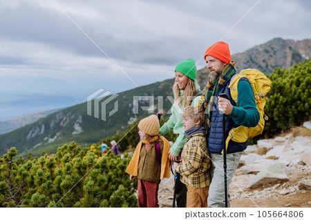 Happy family hiking together and enjoying the view in autumn mountains. Happy family hiking together and enjoying the view in autumn mountains. 105664806