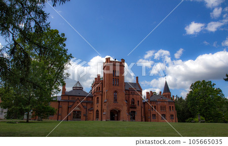 Red brick manor house in the style of English castles. Red brick manor house in the style of English castles. 105665035