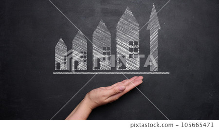 Chalk drawn houses and up arrow. the concept of rising real estate prices. High rent, higher mortgage rates 105665471