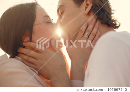 Couple in a summer park. Man in a white t-shirt. Couple in a summer park. Man in a white t-shirt. 105667240