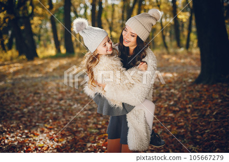 Beautiful mother with daughter. Family in a autumn park. Golden autumn 105667279